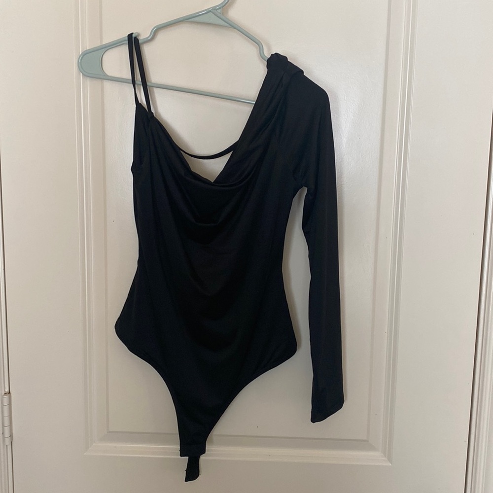 One shoulder black body suit.